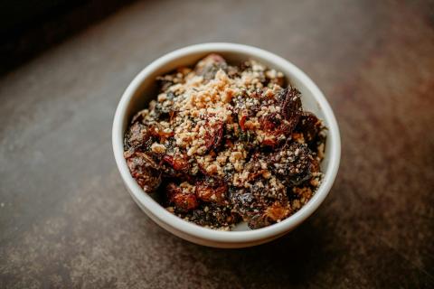 a white bowl filled with food on top of a table - indicative photo for the Hokkien Noodle group