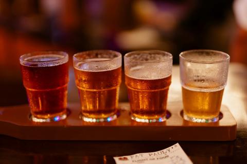 Four glasses of beer on a wooden tray - indicative photo for the Beer group