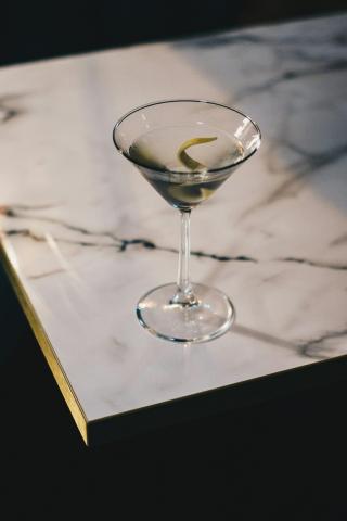 a glass of champagne on a table - indicative photo for the Sparkling Wine group