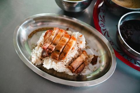 Sliced crispy pork belly over steamed rice