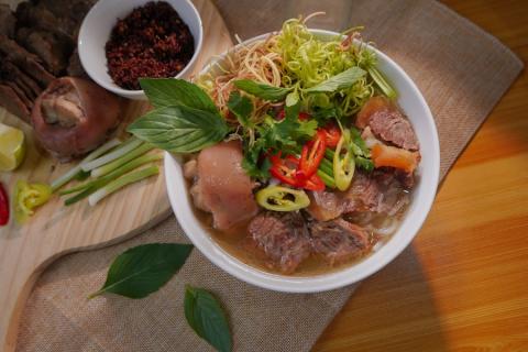 Spicy Hue beef noodle soup with pork hock, chilli and herbs